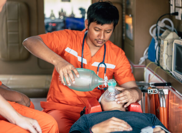 paramedic mobile car medical emergency team working in action help first aid save people life at accident site outdoors